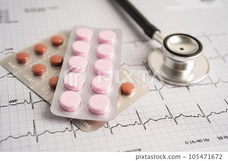 Stethoscope on electrocardiogram ECG with capsule drug, heart wave, heart attack, cardiogram report. 105471672