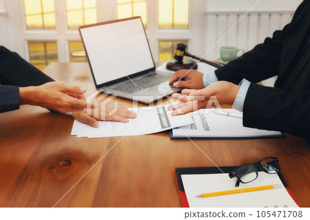 The lawyer submits a contract document to the client at table in office. Sign a contract business. Treaty of the law. 105471708