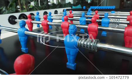 Football table or soccer table game with plastic player figurine. Mini Soccer game which famous in past and be collectable item for foosball lover. Play by two hand control each row of player figurine 105472779