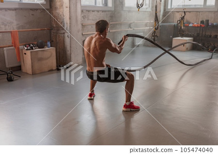 Photo of strong man training in gym 105474040