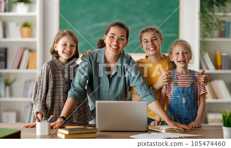 Happy kids and teacher at school Happy kids and teacher at school 105474460