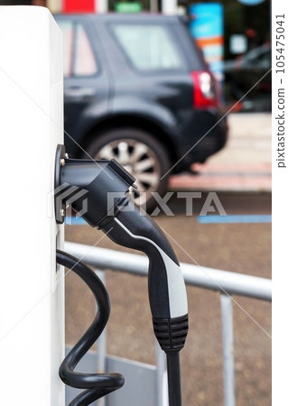 Electric car charging station with plug closeup. Power supply point for hybrid or electrical vehicle Electric car charging station with plug closeup. Power supply point for hybrid or electrical vehicle 105475041