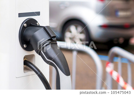 Electric car charging station with plug closeup. Power supply point for hybrid or electrical vehicle Electric car charging station with plug closeup. Power supply point for hybrid or electrical vehicle 105475043