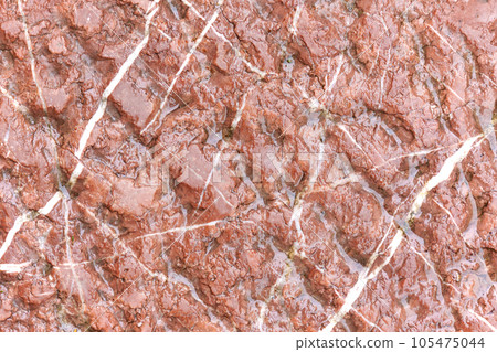Wet stone wall. Water on a rock surface. Brown abstract background Wet stone wall. Water on a rock surface. Brown abstract background 105475044