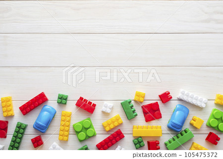 Colorful plastic toy blocks on white wooden background with copy space. 105475372