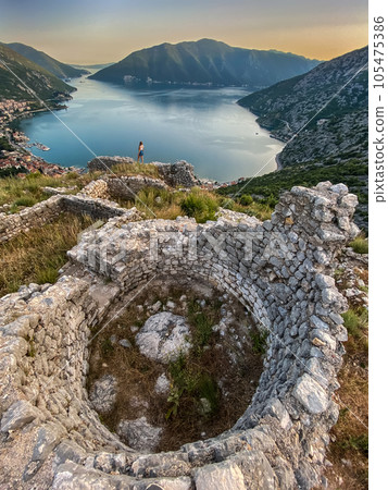 Woman Walking among Ruins of Ancient Fortress Woman Walking among Ruins of Ancient Fortress 105475386