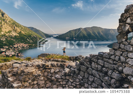 Woman Standing among Ruins of Ancient Fortress Woman Standing among Ruins of Ancient Fortress 105475388