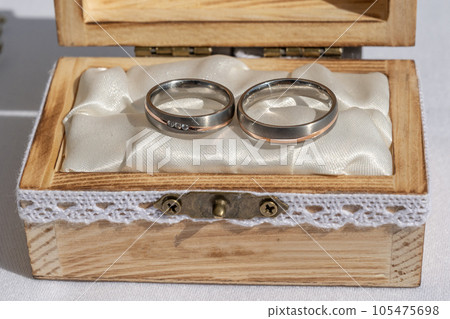 wedding ring pillow burlap in wooden box in front of flower bouquet rings of love 105475698