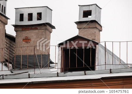 Metal roof with railings, chimneys and attic window Metal roof with railings, chimneys and attic window 105475761