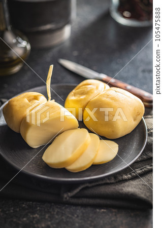 Smoked scamorza cheese on plate. 105475888