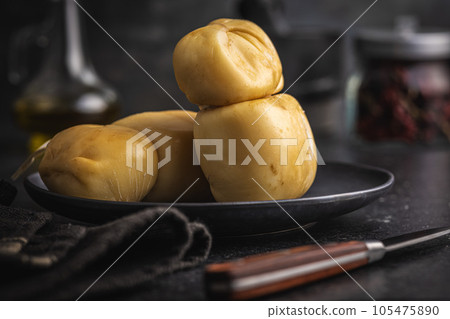 Smoked scamorza cheese on plate. 105475890