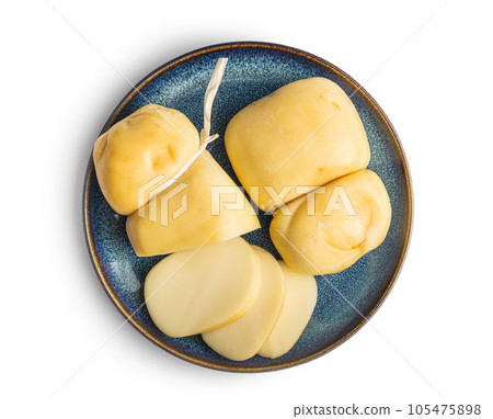 Smoked scamorza cheese on plate isolated on white background. 105475898