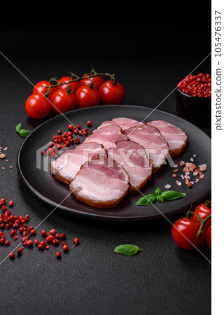 Delicious smoked bacon with salt, spices and herbs 105476337