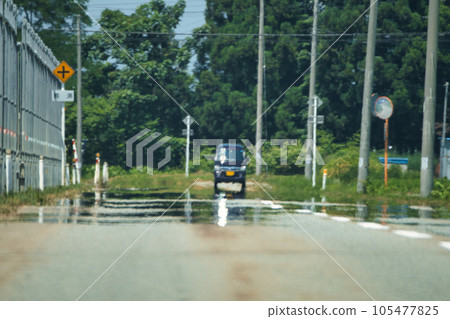 Muddy water on the road in midsummer 105477825