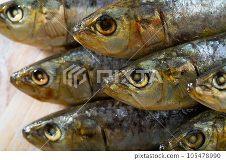 Salted and pressed sardines on wooden table 105478990