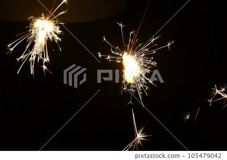 flying sparks of handheld fireworks flying sparks of handheld fireworks 105479042