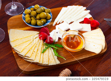Cheese plate with raspberry and olives Cheese plate with raspberry and olives 105479319