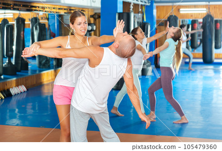 Young woman exercising chin strike Young woman exercising chin strike 105479360