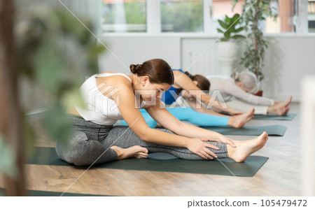 Young woman doing yoga in fitness studio Young woman doing yoga in fitness studio 105479472