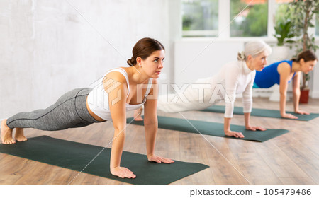 Young woman doing yoga in fitness studio 105479486