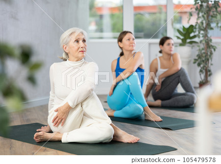 Elderly woman doing yoga in fitness studio Elderly woman doing yoga in fitness studio 105479578