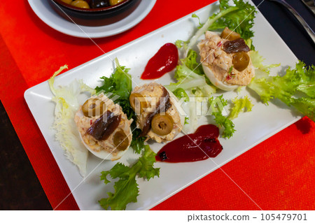 Deviled eggs with olives. Stuffed egg halves 105479701