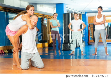 Young woman performing chokehold Young woman performing chokehold 105479725