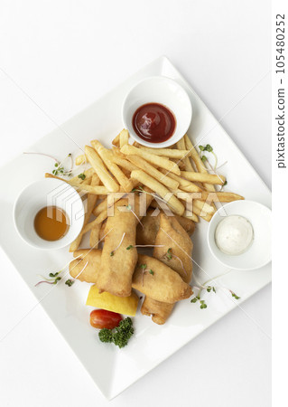 british traditional fish and chips meal in restaurant on white plate british traditional fish and chips meal in restaurant on white plate 105480252
