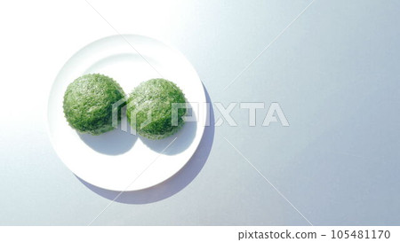 Two mugwort steamed buns on a white plate Two mugwort steamed buns on a white plate 105481170