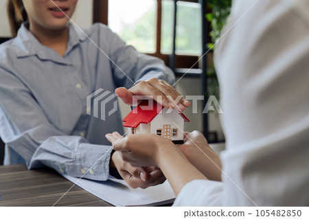 agent hand cover house model. real estate, insurance and property concepts after purchase agent hand cover house model. real estate, insurance and property concepts after purchase 105482850