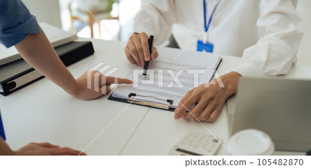 Closeup hand of employee discuss report together in the office Closeup hand of employee discuss report together in the office 105482870