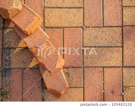 Old brickwork. Bricks on the ground. Construction works. Brick block. Demolition work. Stones on the ground. 105483128