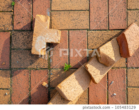 Old brickwork. Bricks on the ground. Construction works. Brick block. Demolition work. Stones on the ground. 105483129