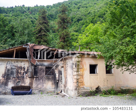 A dilapidated abandoned building in nature. Ruins of an old house. Dwelling. 105483131
