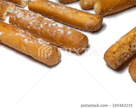 Sesame biscuits on a white background. Biscuits are elongated in the form of sticks. Bread products  105483235