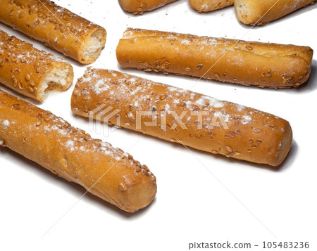 Sesame biscuits on a white background. Biscuits are elongated in the form of sticks.  105483236