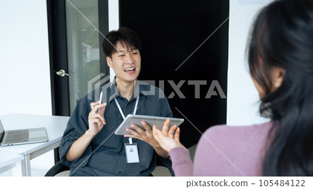 employee discuss business income report in tablet together in the office 105484122