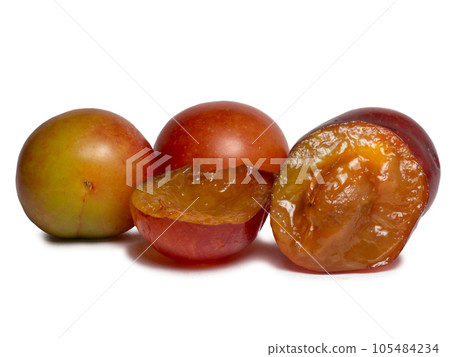 Cherry plum at different stages of maturation. Plum variety. Red and green fruits. Tkemali. Juicy fruit on the table. Compote ingredient Cherry plum at different stages of maturation. Plum variety. Red and green fruits. Tkemali. Juicy fruit on the table. Compote ingredient 105484234