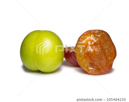 Cherry plum at different stages of maturation. Plum variety. Red and green fruits.  Juicy fruit on the table. Compote ingredient 105484235