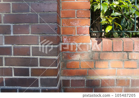 iron fence green leaves 1 on brick wall iron fence green leaves 1 on brick wall 105487205