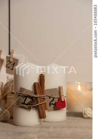 Candle with advent calendar Traditional Burning Christmas Wax Candles with numbers counting down for Christmas. Beautiful Advent At Home. Festive Candlelight And Dark Background Candle with advent calendar Traditional Burning Christmas Wax Candles with numbers counting down for Christmas. Beautiful Advent At Home. Festive Candlelight And Dark Background 105488863