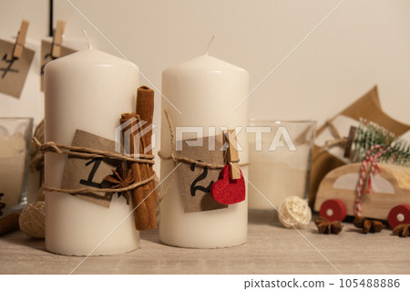Candle with advent calendar Traditional Burning Christmas Wax Candles with numbers counting down for Christmas. Beautiful Advent At Home. Festive Candlelight And Dark Background 105488886