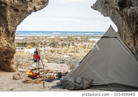 camping solo camp one person camp tent setup sea seaside bonfire rocky place copy space 105489940