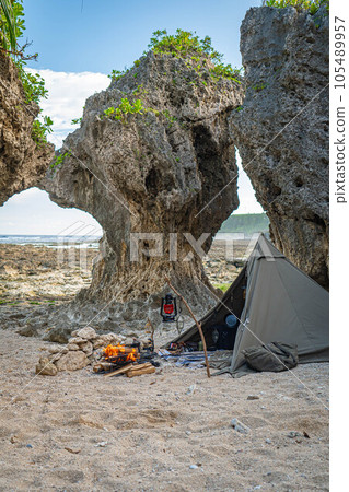 camping solo camp one person camping tent construction sea seaside bonfire rocky place copy space blue sky camping solo camp one person camping tent construction sea seaside bonfire rocky place copy space blue sky 105489957