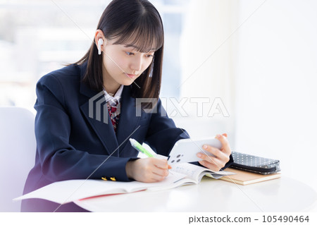 High school girl studying with a smartphone High school girl studying with a smartphone 105490464