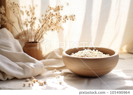 A vase and pot sitting on a table on the window sill 105490964