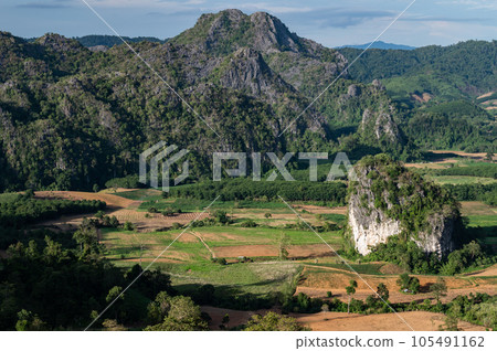 The scenery view of limestone mountains in Phu Langka Forest Park during green season in Phayao province of Thailand. One of the popular tourist attraction in Phayao province. The scenery view of limestone mountains in Phu Langka Forest Park during green season in Phayao province of Thailand. One of the popular tourist attraction in Phayao province. 105491162
