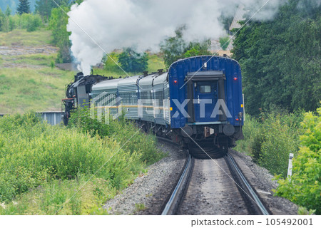 Retro steam train moves away. Retro steam train moves away. 105492001