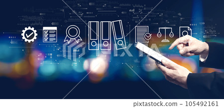 Compliance theme with businessman using a tablet computer Compliance theme with businessman using a tablet computer 105492161