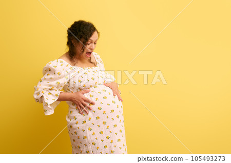 Pregnant woman, mother to-be holds belly, cries and shouts, isolated on yellow. Easy delivery, pregnancy and parturition Pregnant woman, mother to-be holds belly, cries and shouts, isolated on yellow. Easy delivery, pregnancy and parturition 105493273